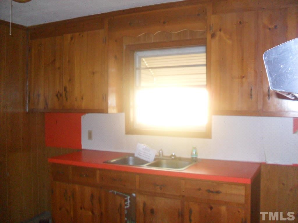 4611 Bragg Road Durham, NC 27704 - Photo 5 of 10 a bathroom with a sink and a mirror
