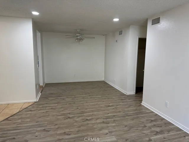 a view of a room with wooden floor