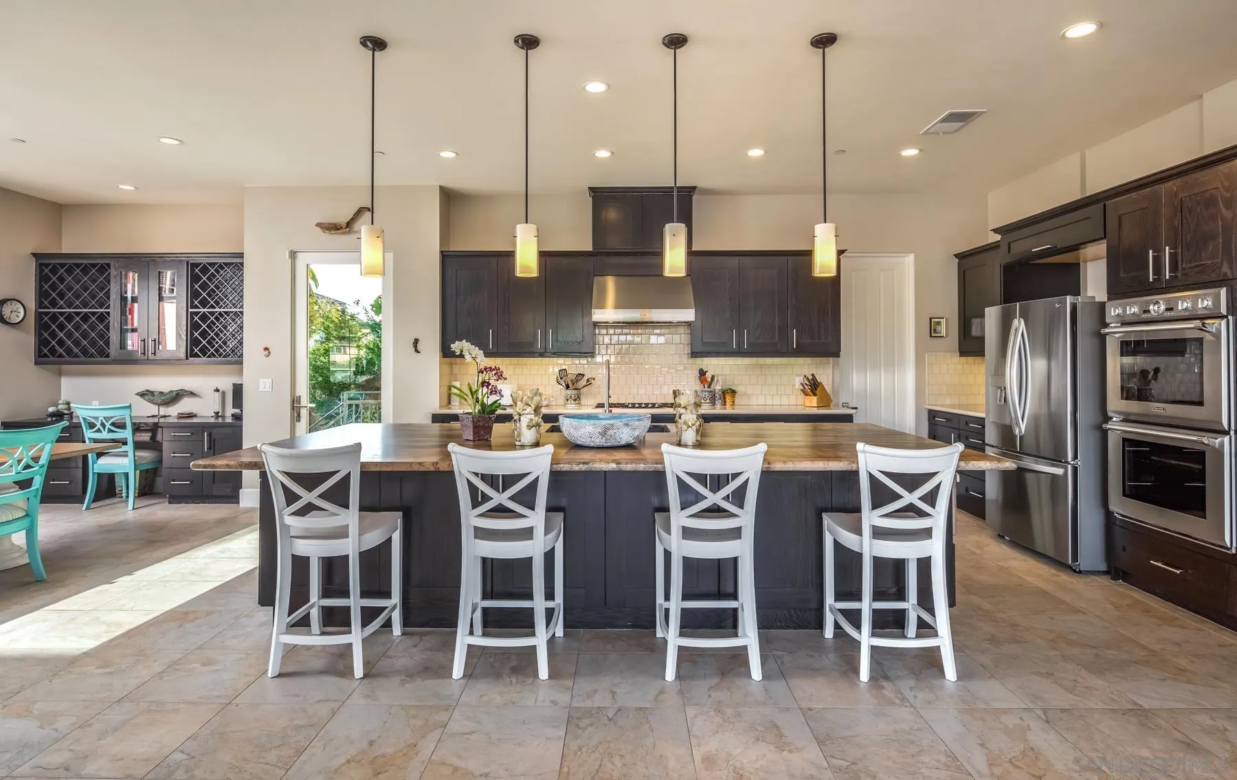 1815 Oak Avenue Carlsbad, CA 92008 - Photo 11 of 46 a dining room with stainless steel appliances kitchen island granite countertop a table and chairs
