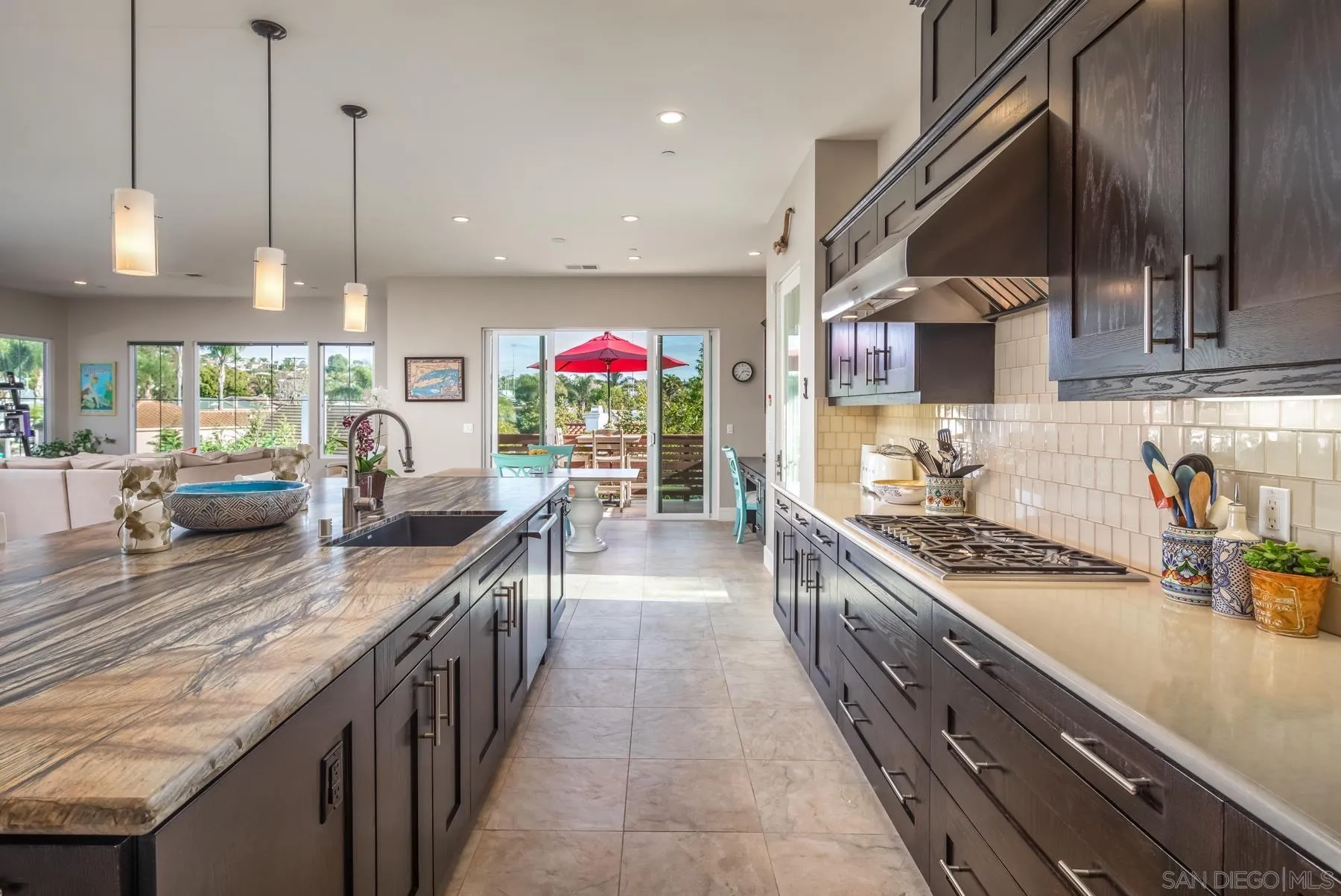 1815 Oak Avenue Carlsbad, CA 92008 - Photo 12 of 46 a kitchen with kitchen island granite countertop lots of counter top space and stainless steel appliances