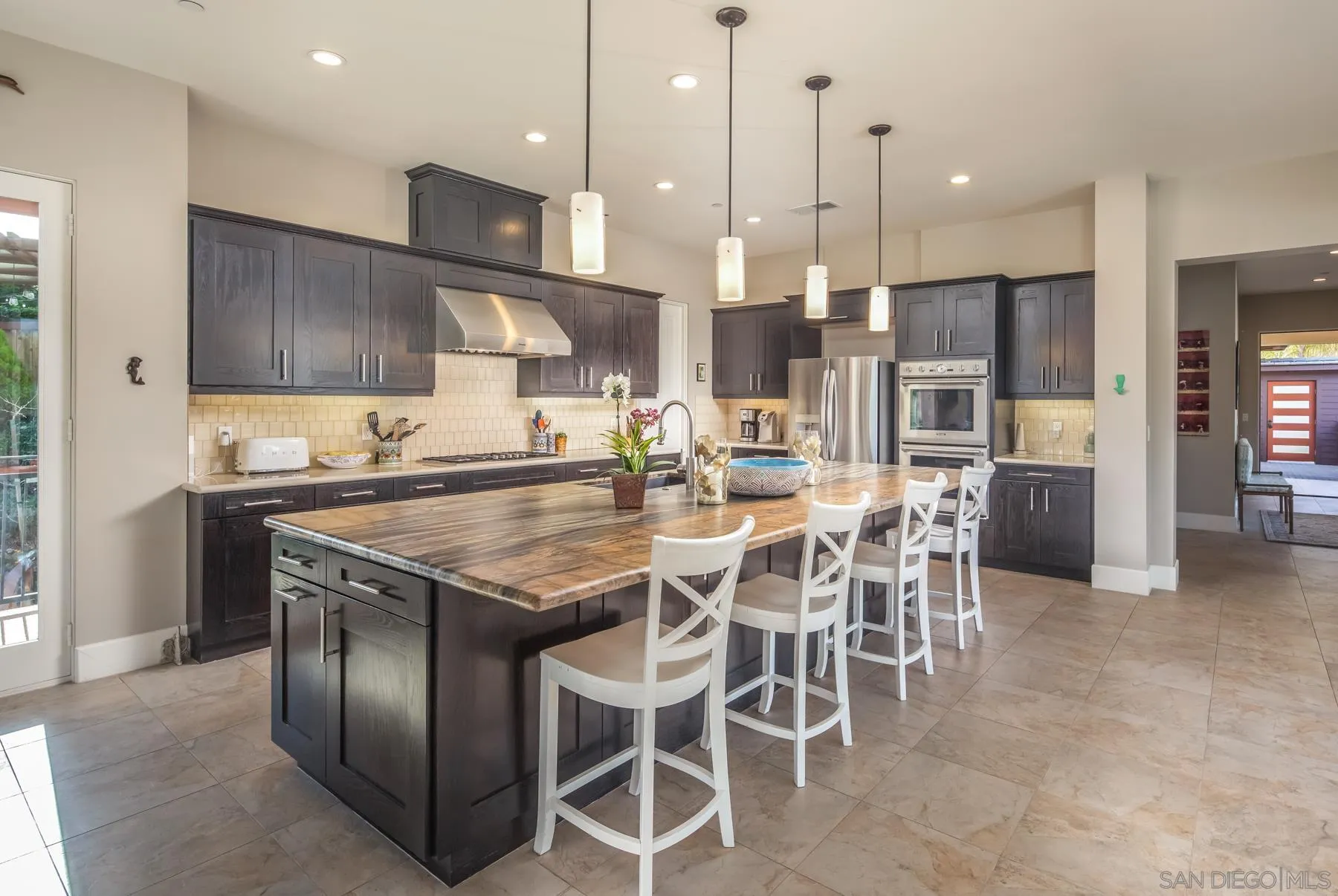 1815 Oak Avenue Carlsbad, CA 92008 - Photo 13 of 46 a kitchen with stainless steel appliances granite countertop a stove top oven a sink refrigerator and cabinets