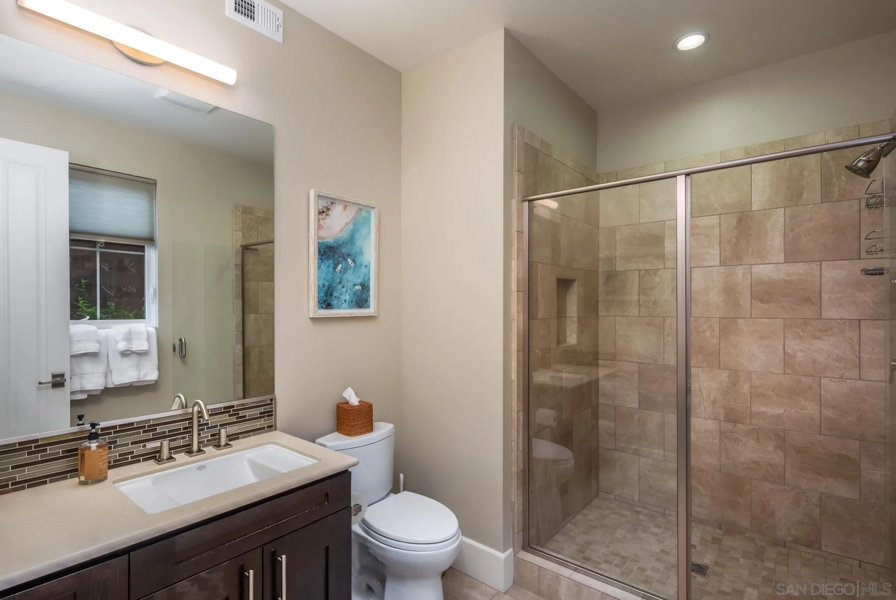 1815 Oak Avenue Carlsbad, CA 92008 - Photo 31 of 46 a bathroom with a sink mirror a toilet and shower