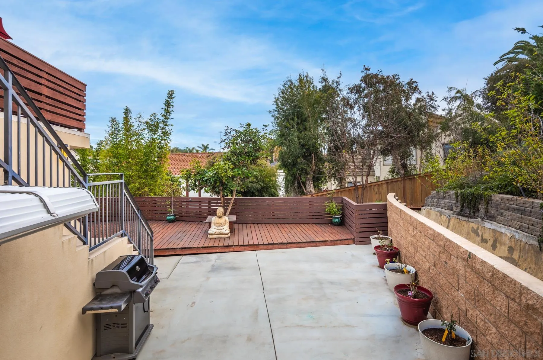 1815 Oak Avenue Carlsbad, CA 92008 - Photo 43 of 46 a view of a patio with couches and a table and chairs with wooden fence