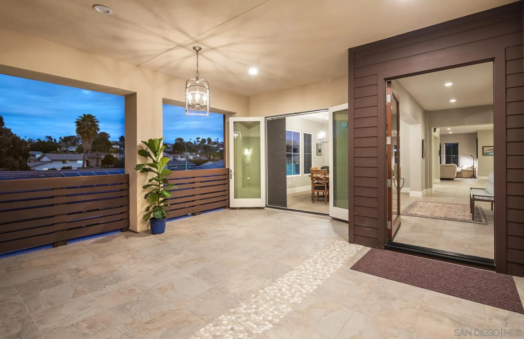 1815 Oak Avenue Carlsbad, CA 92008 - Photo 8 of 46 a view of a hallway with a chandelier and fireplace