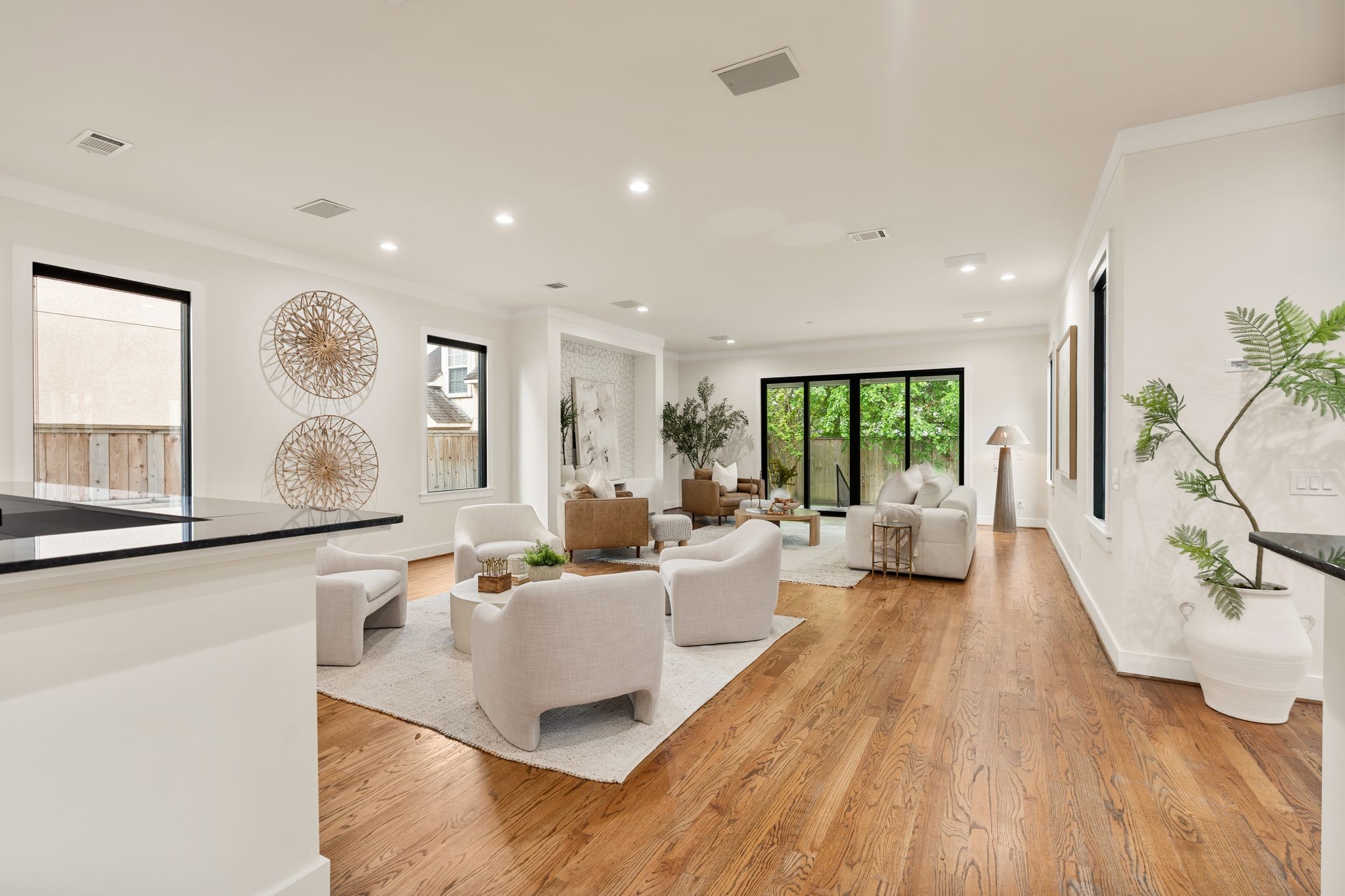 3847 Durness Way Houston, TX 77025 - Photo 23 of 48 Just before heading upstairs, you’re greeted with a beautiful view of the living room, featuring sliding glass doors that open to the covered patio and backyard.
