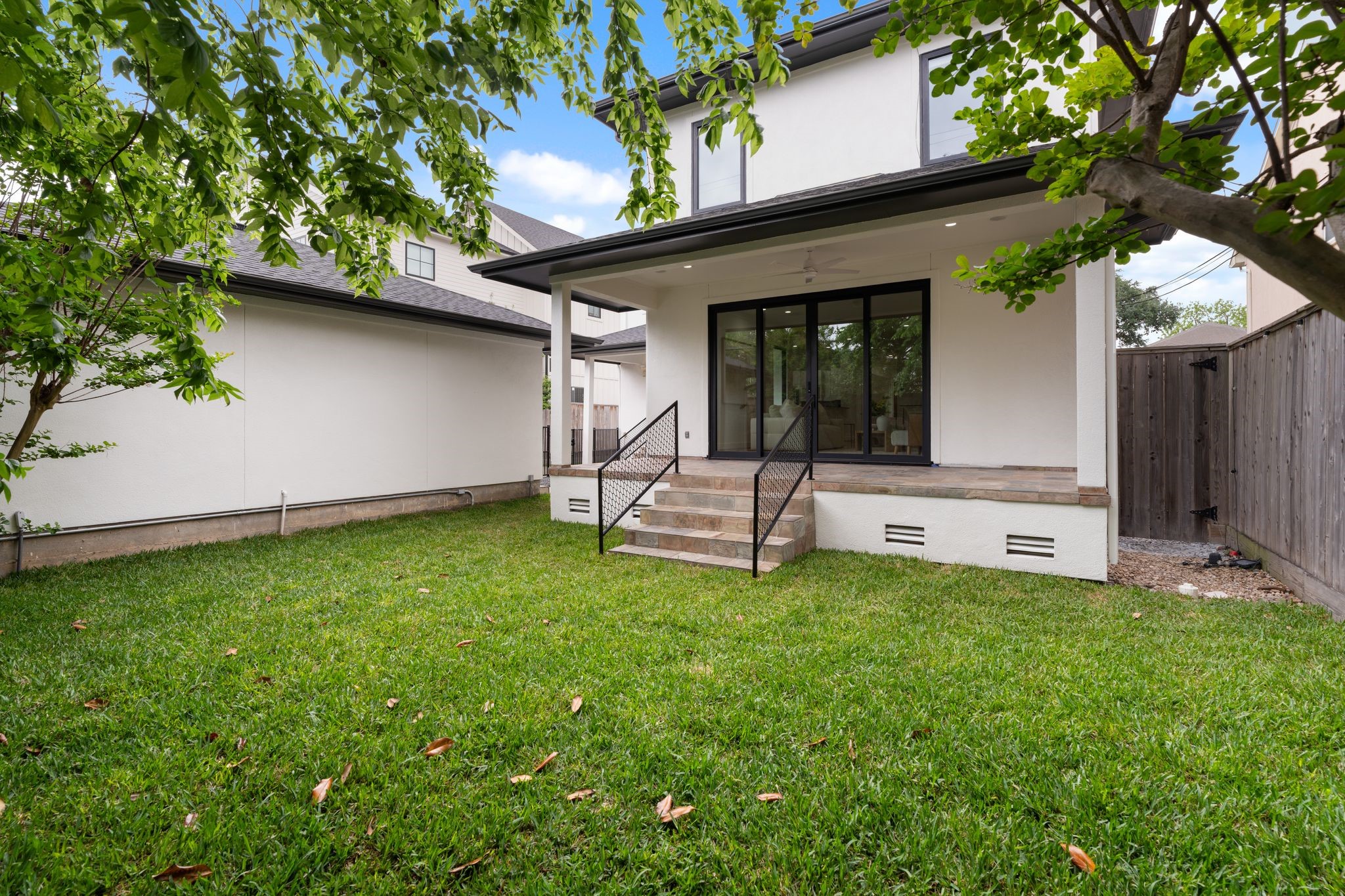 3847 Durness Way Houston, TX 77025 - Photo 40 of 48 This home sits on a generous 7,500 sq ft lot and features two covered patios, a wrought iron gate separating the backyard from the driveway, and a motorized driveway gate for added privacy and convenience.
