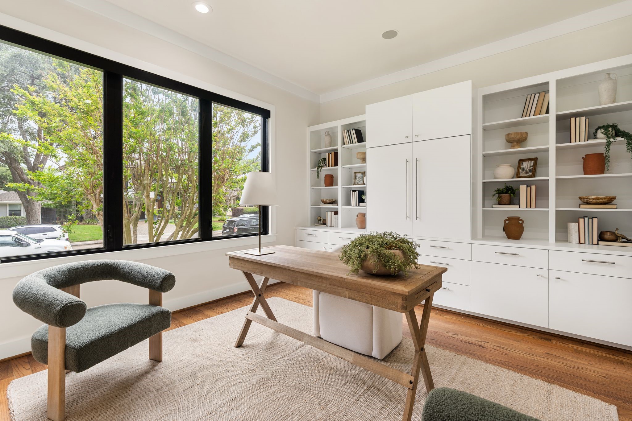 3847 Durness Way Houston, TX 77025 - Photo 6 of 48 Beautiful, secluded front-facing office featuring pocket doors with glass inlay, large windows, and custom built-ins. Includes two additional storage closets with hanging space and private access to a full bath, offering flexibility as a fourth bedroom.