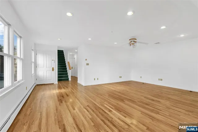 a view of an empty room with wooden floor