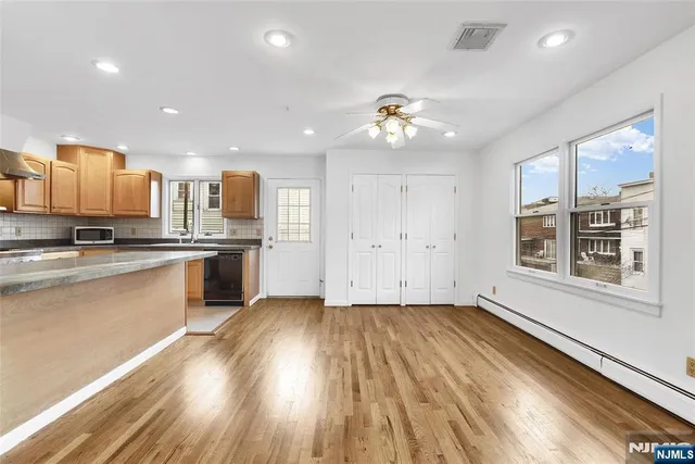 a kitchen with stainless steel appliances a sink stove and cabinets