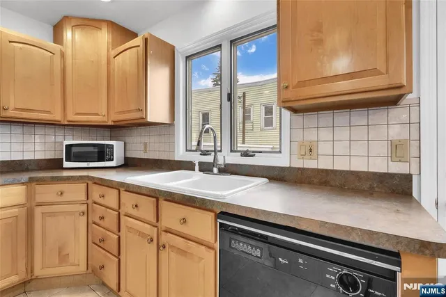 a kitchen with stainless steel appliances granite countertop a stove a sink and a granite counter tops