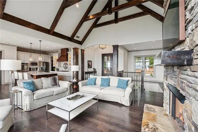 a kitchen with stainless steel appliances granite countertop a sink a stove and a wooden floors