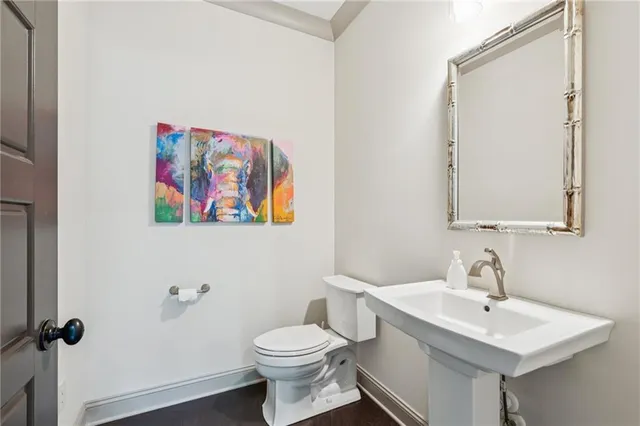 a kitchen with stainless steel appliances granite countertop a sink and cabinets with wooden floor