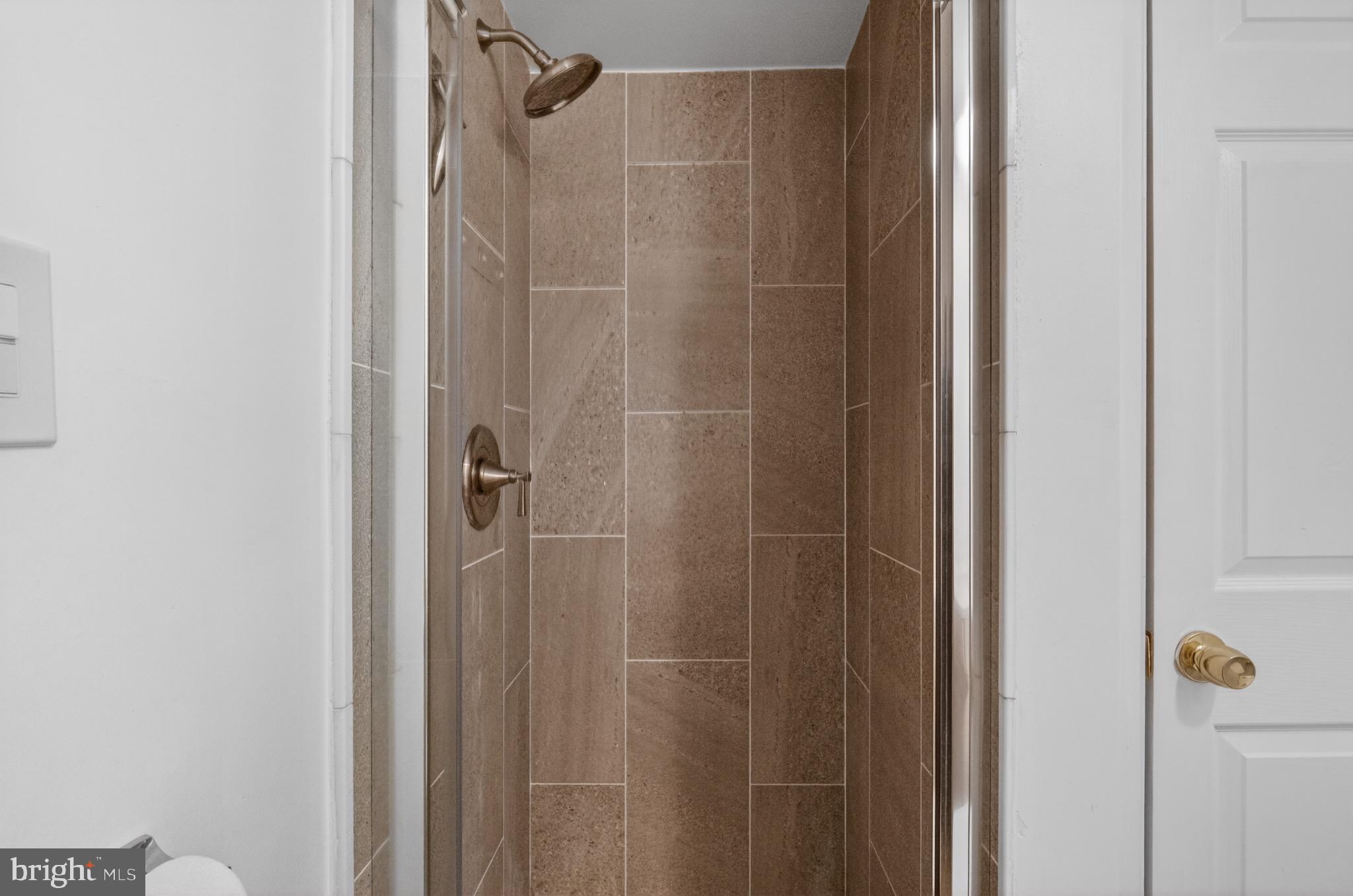 3301 Hewitt Avenue, Unit 403 Silver Spring, MD 20906 - Photo 11 of 19 Sleek, modern shower with elegant tiles.