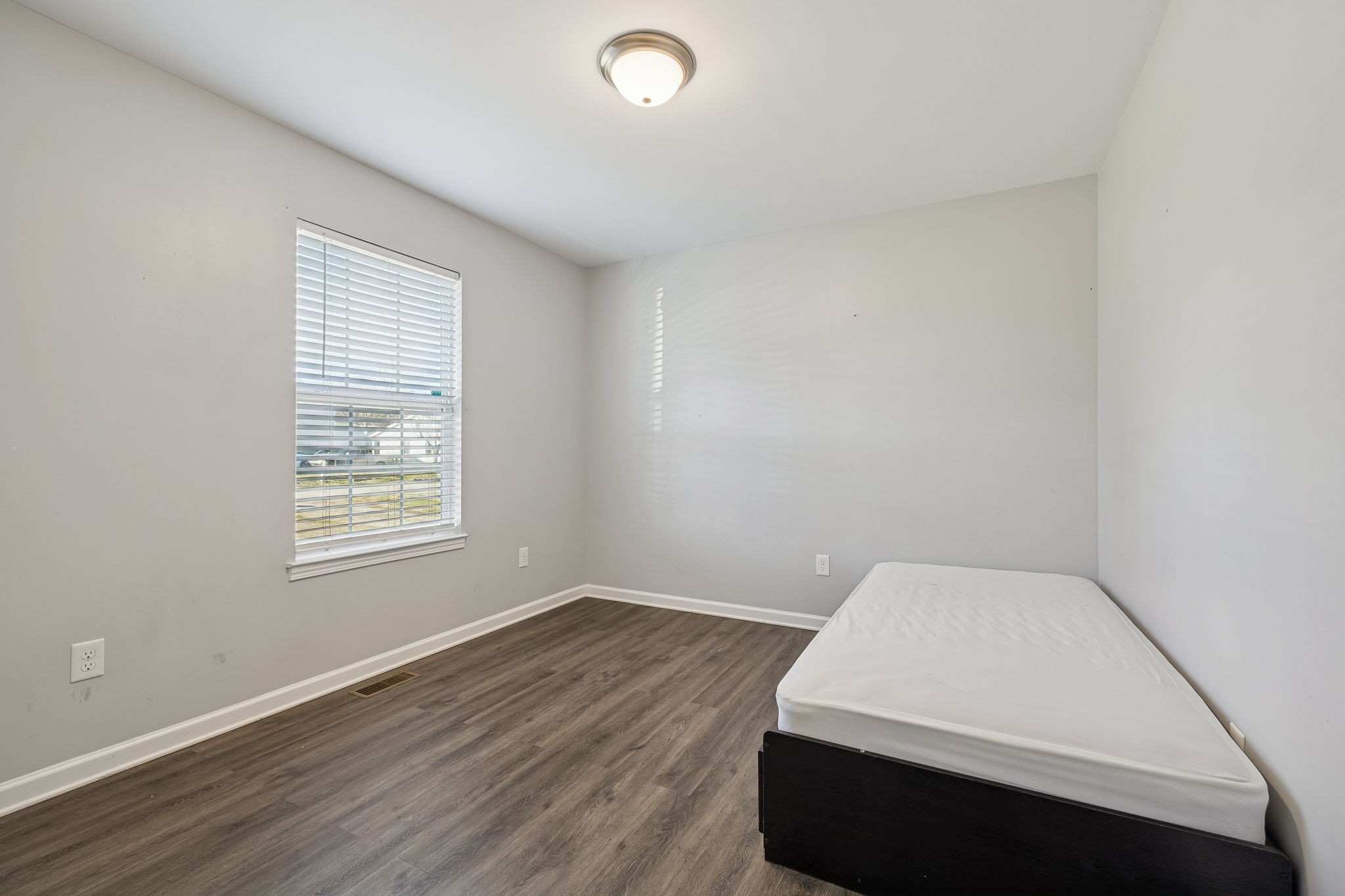 444 Edgewood Street Alexandria, TN 37012 - Photo 15 of 22 an empty room with wooden floor and windows