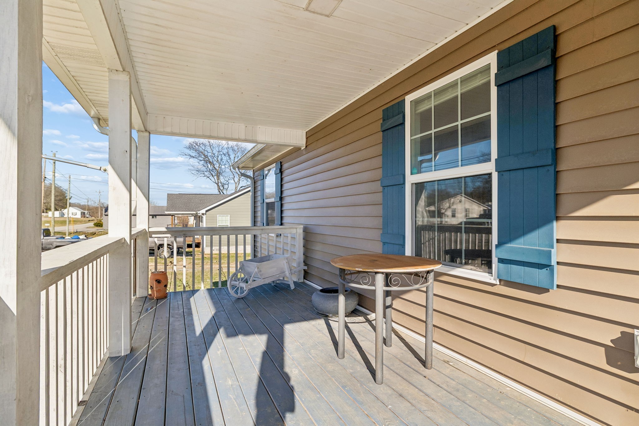 444 Edgewood Street Alexandria, TN 37012 - Photo 2 of 22 a balcony with wooden floor table and chairs