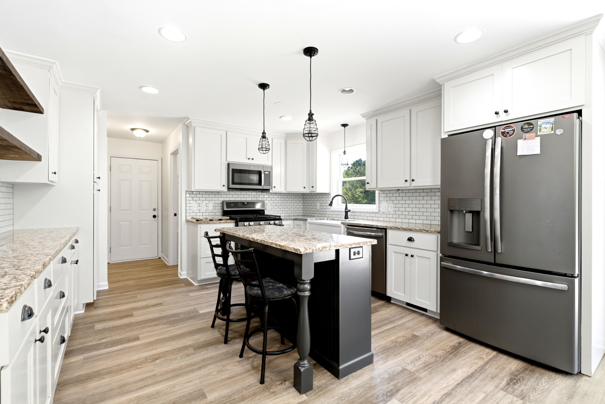 3434 Kinneys Road Cedar Hill, TN 37032 - Photo 27 of 90 a kitchen with stainless steel appliances a refrigerator stove microwave and white cabinets