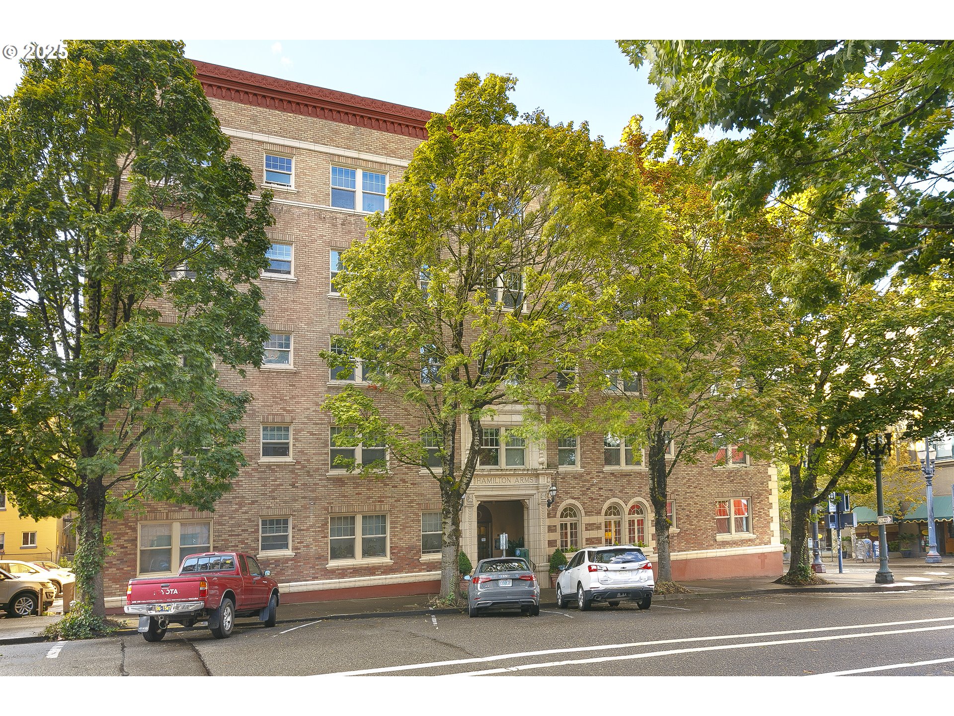 709 Southwest 16th Avenue, Unit 203 Portland, OR 97205 - Photo 15 of 16 a view of a building and car parked on the road