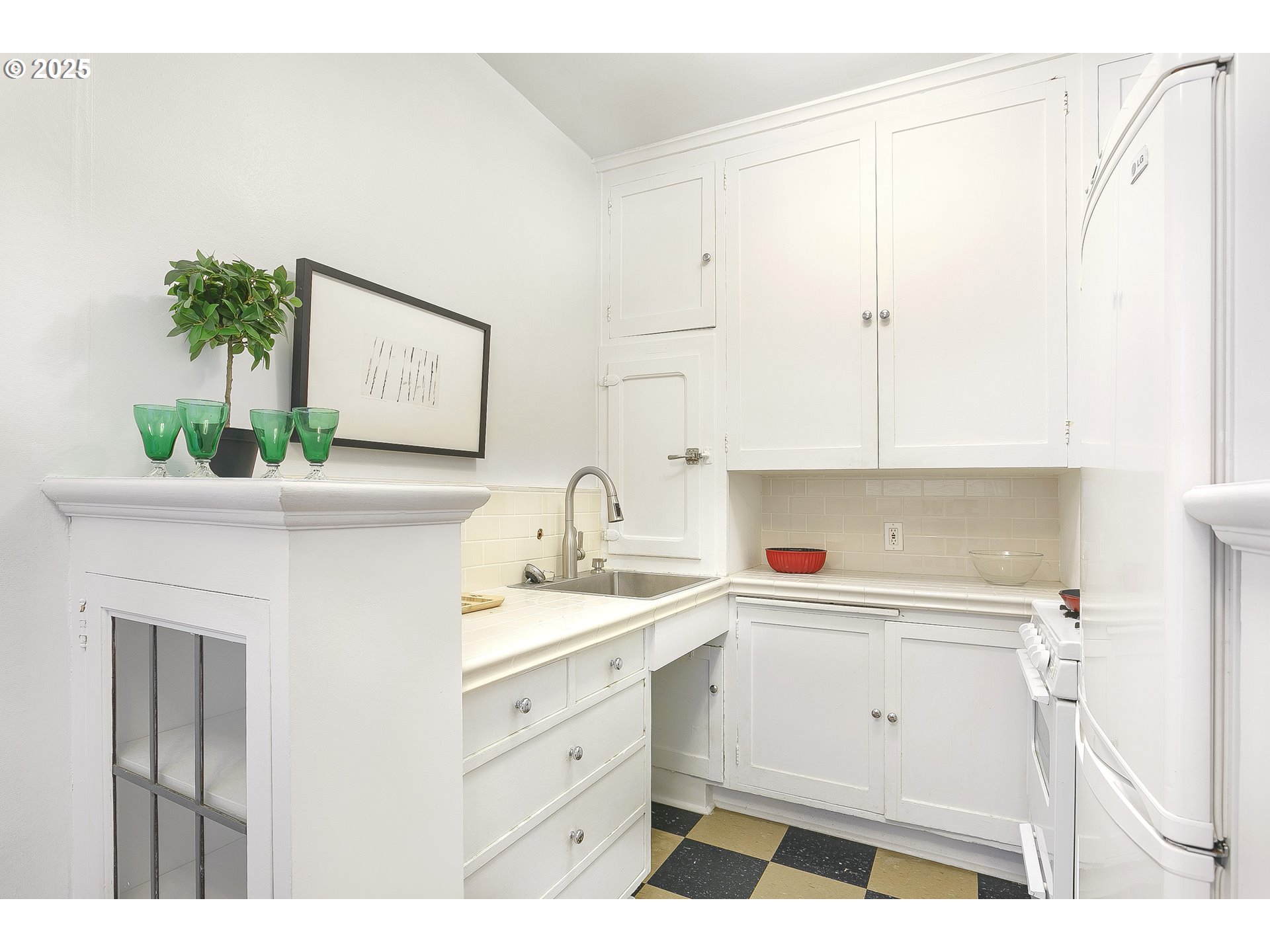 709 Southwest 16th Avenue, Unit 203 Portland, OR 97205 - Photo 7 of 16 a kitchen with a sink and cabinets