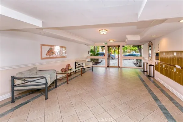 a lobby with furniture and large windows