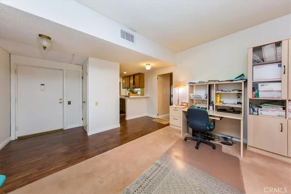 a view of a livingroom with workspace and a window