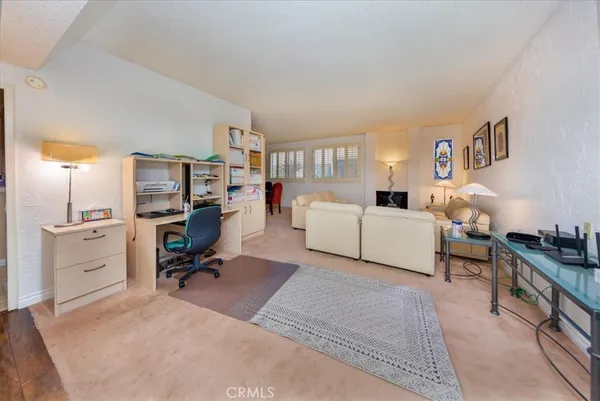 a living room with furniture and a dresser
