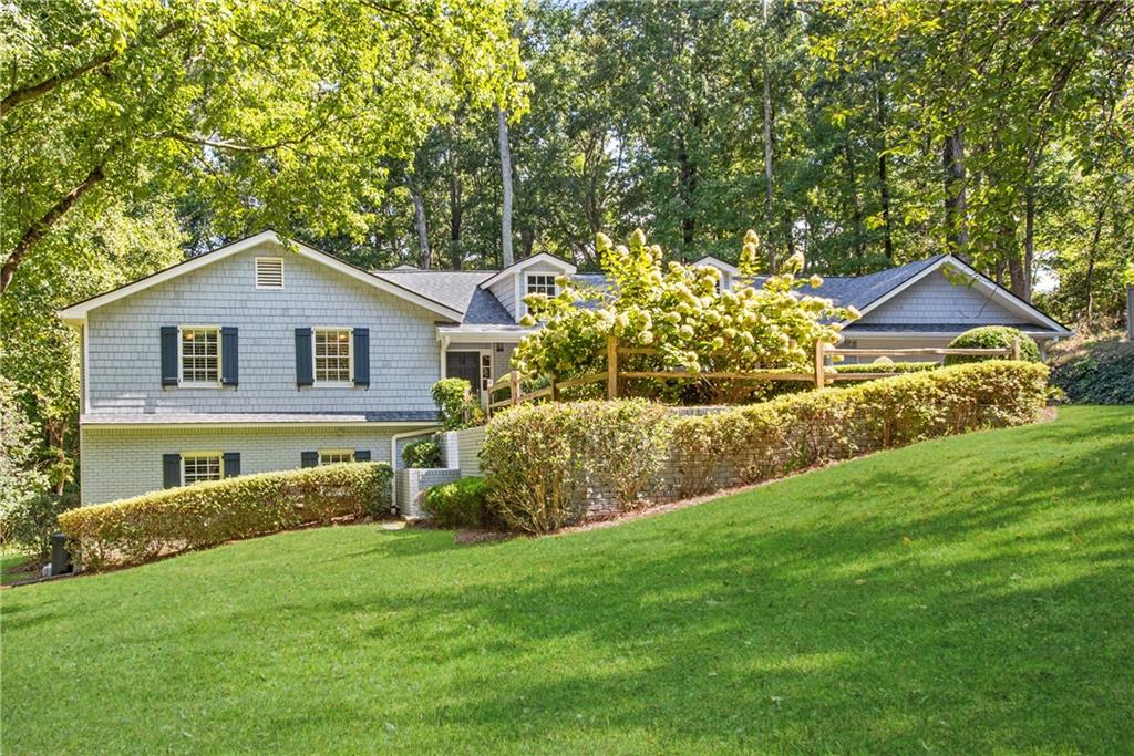 13265 Bethany Road Milton, GA 30009 - Photo 1 of 1 a front view of a house with a garden