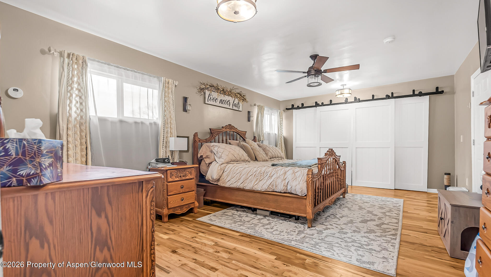 134 4th Street Meeker, CO 81641 - Photo 14 of 47 a spacious bedroom with a bed and a chandelier