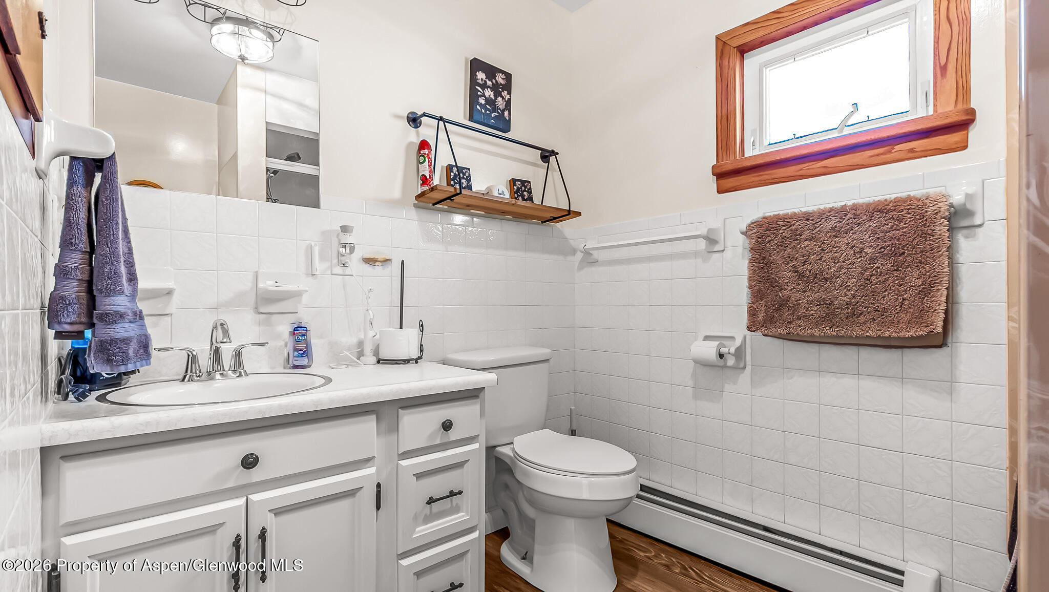 134 4th Street Meeker, CO 81641 - Photo 18 of 47 a bathroom with a toilet sink and mirror