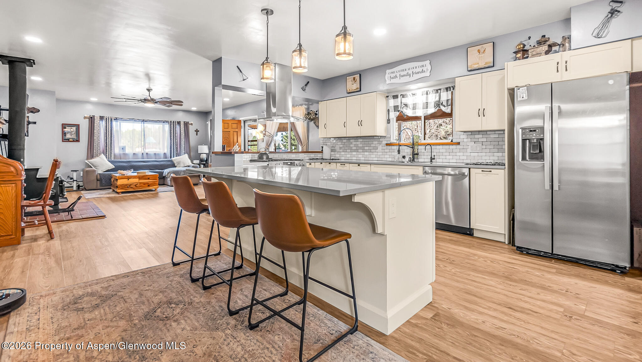 134 4th Street Meeker, CO 81641 - Photo 2 of 47 a kitchen with stainless steel appliances granite countertop a refrigerator a stove and a wooden floors