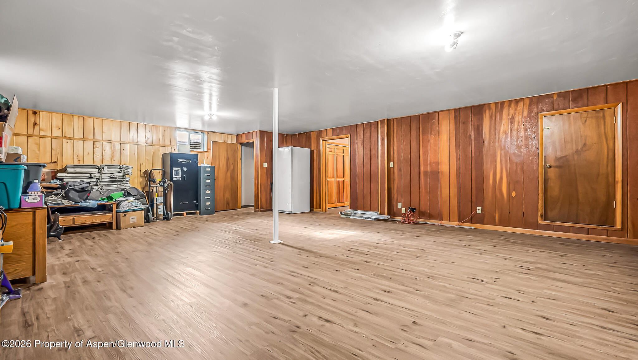 134 4th Street Meeker, CO 81641 - Photo 28 of 47 an empty room with sliding door and wooden floor