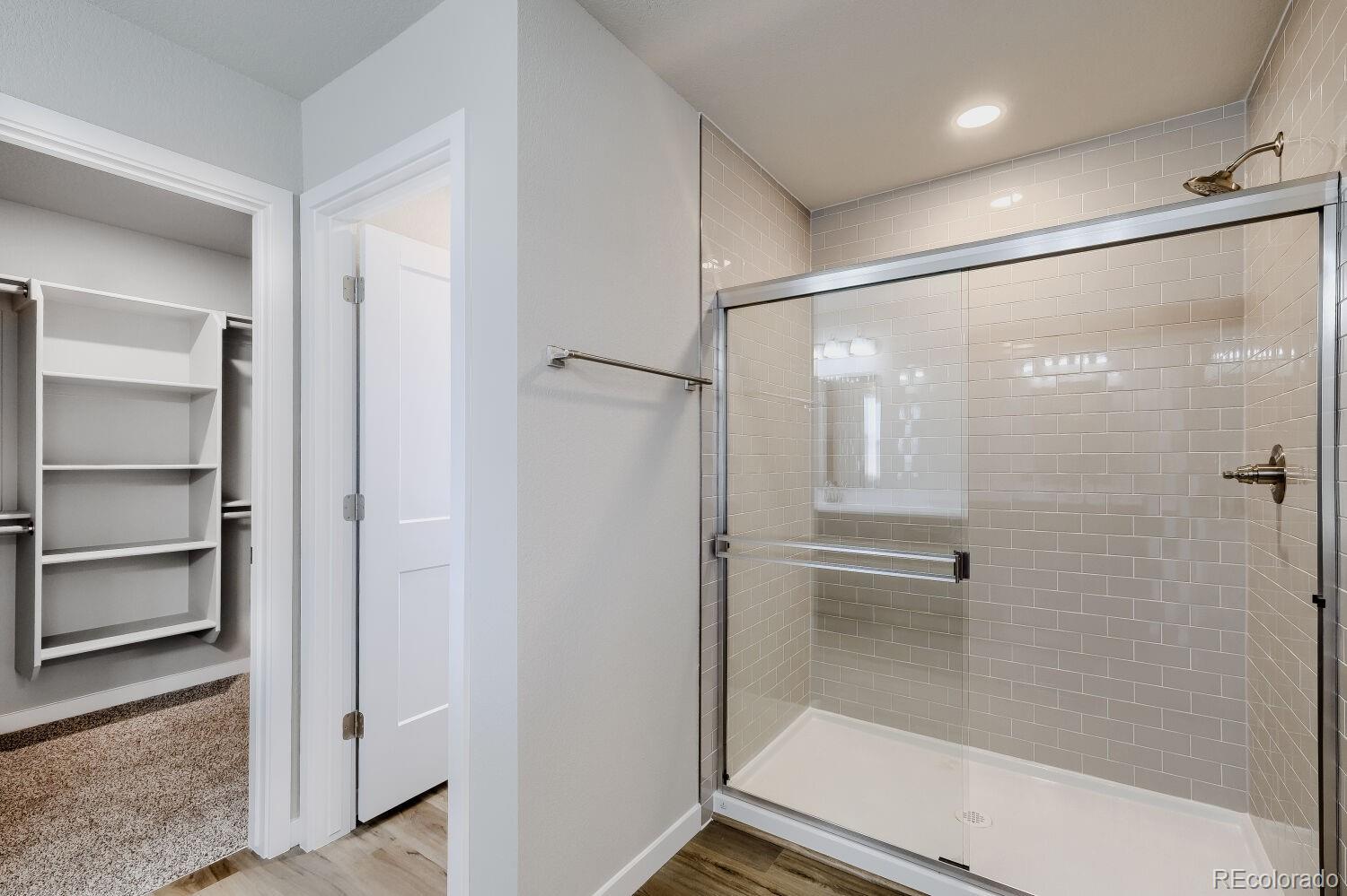 471 Atchison Way Calhan, CO 80808 - Photo 21 of 31 a bathroom with a glass shower door