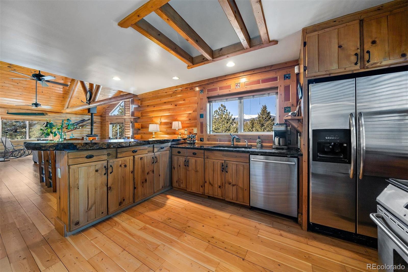55 Rd P78 Bailey, CO 80421 - Photo 11 of 43 a kitchen with stainless steel appliances granite countertop a refrigerator a sink and a stove