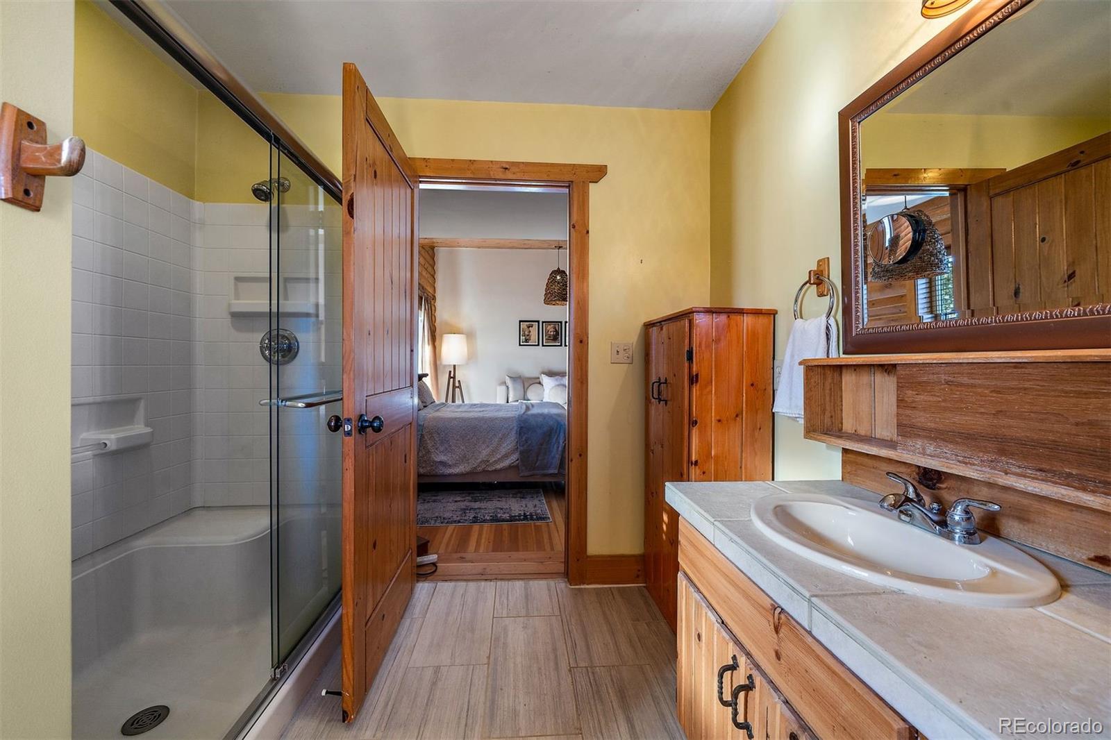 55 Rd P78 Bailey, CO 80421 - Photo 17 of 43 a bathroom with a sink a mirror and shower