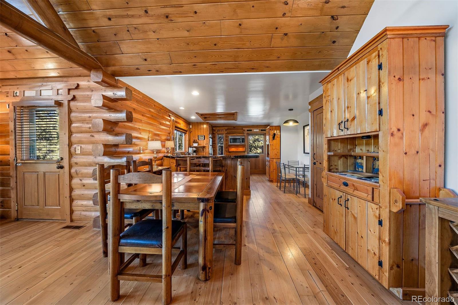 55 Rd P78 Bailey, CO 80421 - Photo 19 of 43 a dining room with stainless steel appliances kitchen island granite countertop a table chairs and a refrigerator