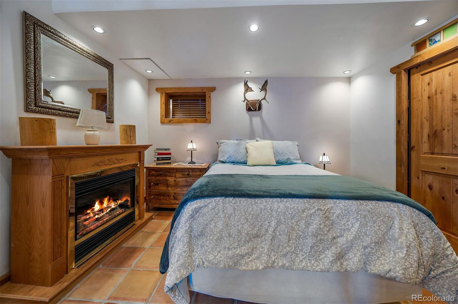 55 Rd P78 Bailey, CO 80421 - Photo 23 of 43 a bedroom with a bed and a fireplace