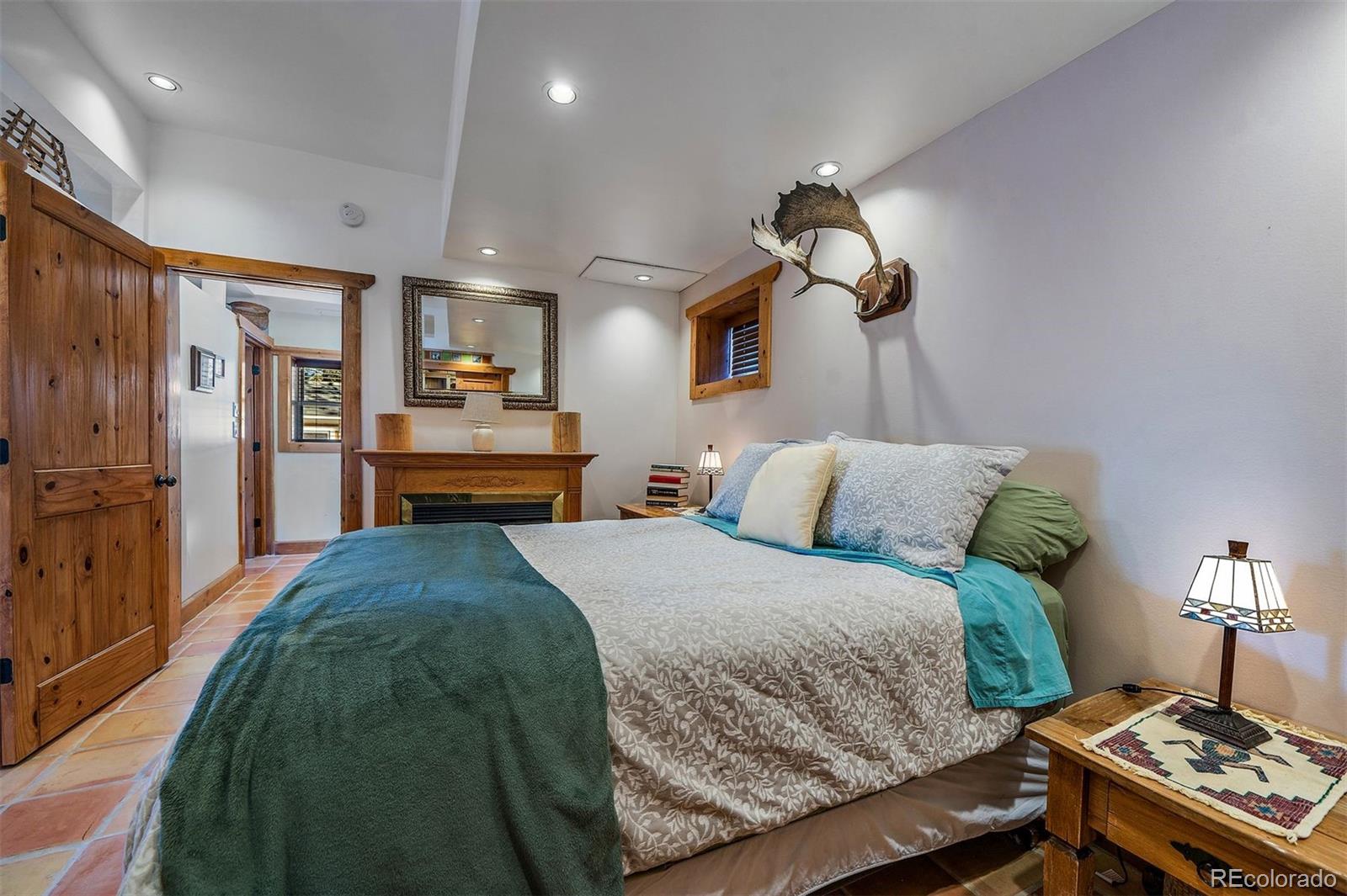 55 Rd P78 Bailey, CO 80421 - Photo 24 of 43 a bedroom with a bed and a chandelier