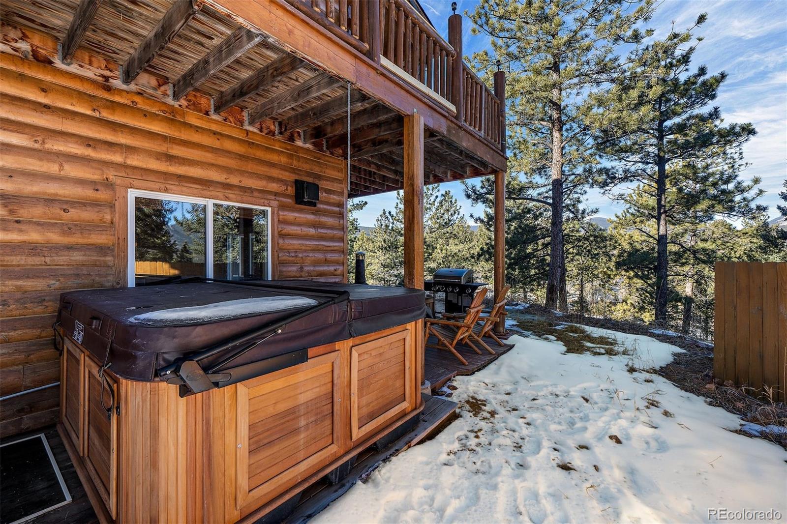 55 Rd P78 Bailey, CO 80421 - Photo 33 of 43 a backyard of a house with wooden fence and large trees