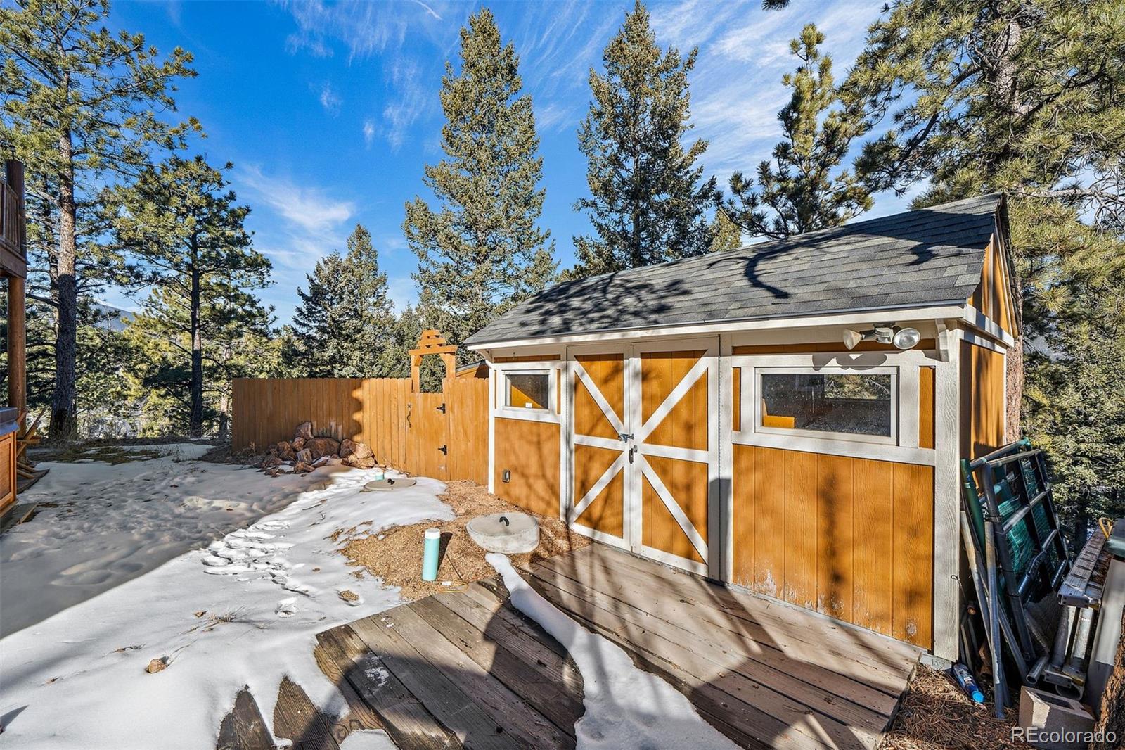 55 Rd P78 Bailey, CO 80421 - Photo 34 of 43 a view of a backyard with wooden fence and large trees