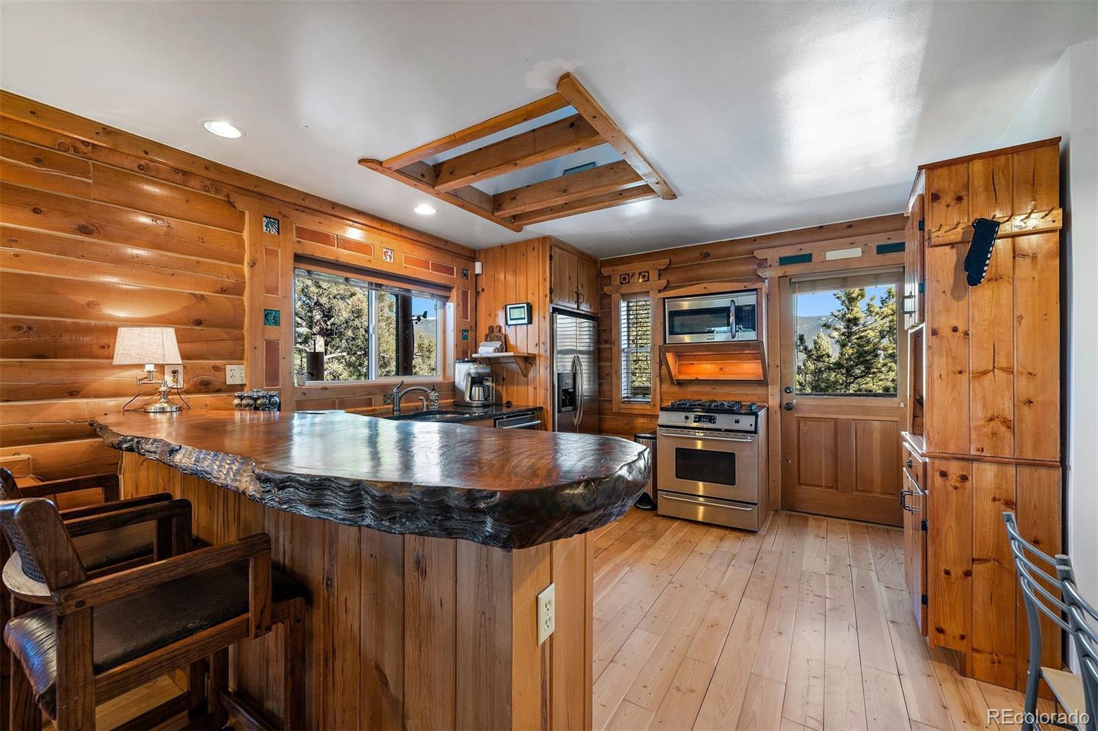 55 Rd P78 Bailey, CO 80421 - Photo 9 of 43 a kitchen with stainless steel appliances granite countertop a stove and a wooden floors