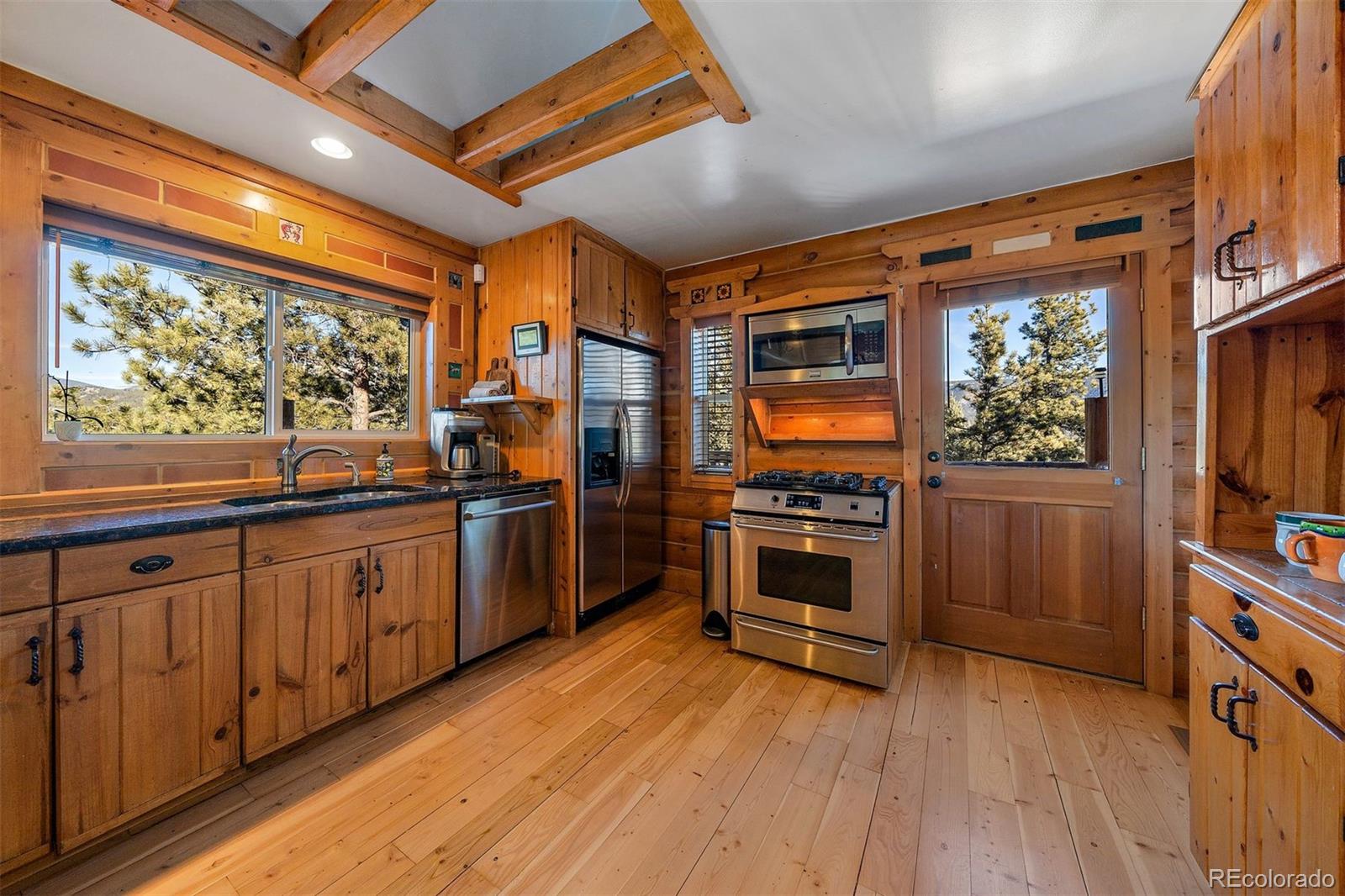 55 Rd P78 Bailey, CO 80421 - Photo 10 of 43 a open kitchen with stainless steel appliances granite countertop a stove a refrigerator a sink and dishwasher with wooden floor