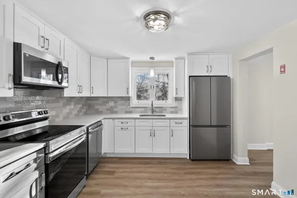 a kitchen with a refrigerator stove and microwave