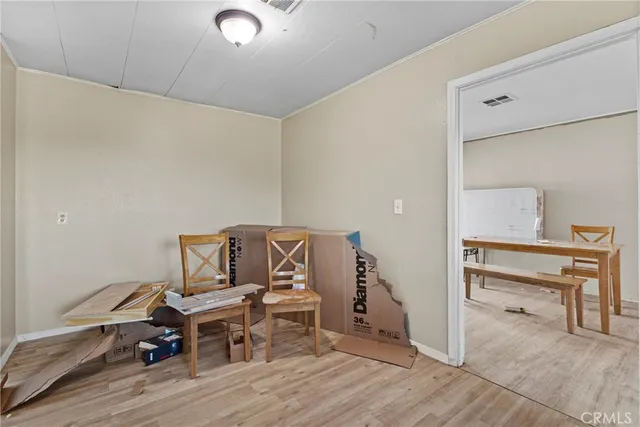 a living room with a bed furniture and a wooden floor