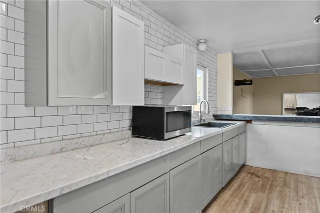 a kitchen with granite countertop a sink and a stove