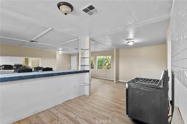 a kitchen with granite countertop a stove and a wooden floors