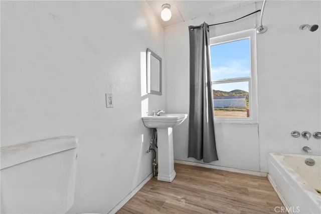 a bathroom with a sink a mirror and a bathtub