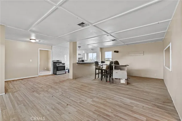 a view of a room with chairs and a table wooden floor