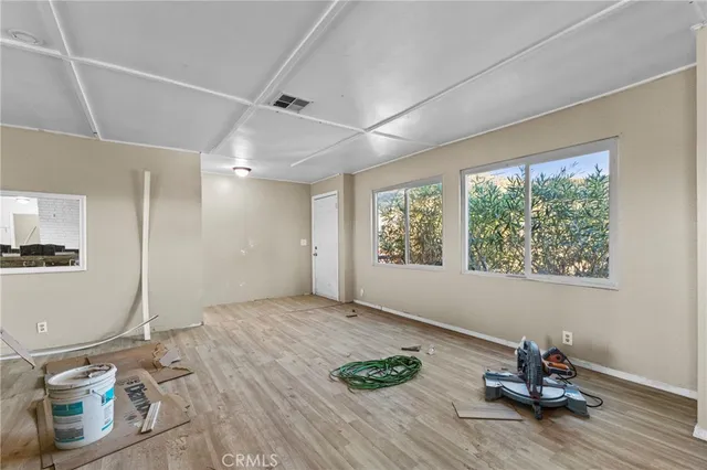 a view of a room with wooden floor and furniture