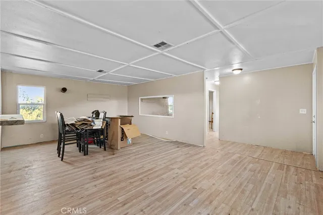 a view of a dining room with furniture and window