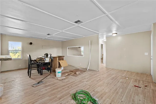 a dining room with wooden floor and breakfast area