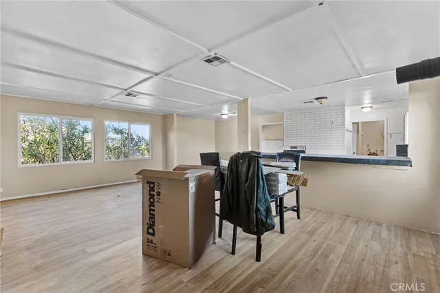 a view of a workspace with furniture and a window